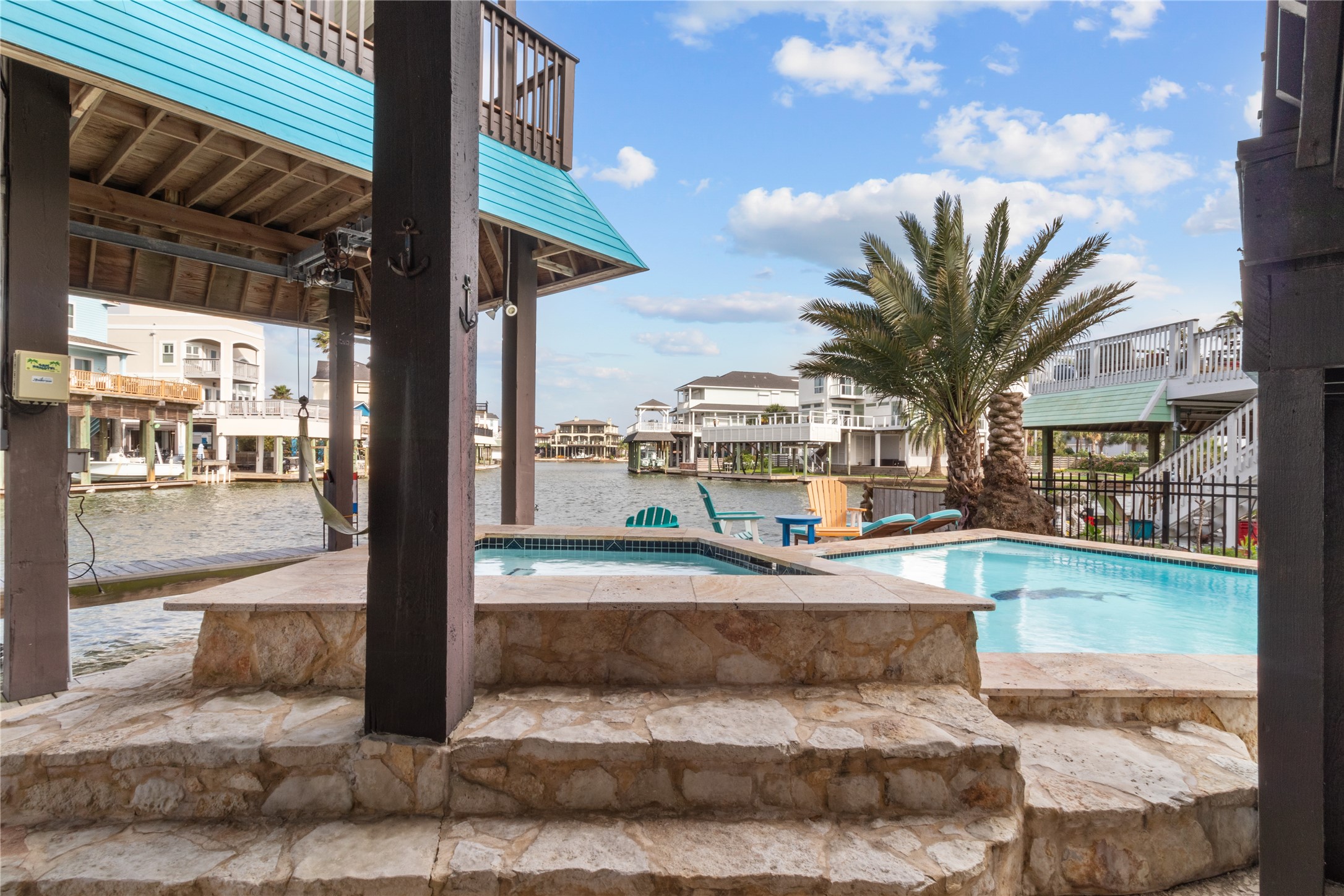 106 Isles End Road Tiki Island, TX 77554 - Photo 39 of 44 a view of a patio with swimming pool table and chairs