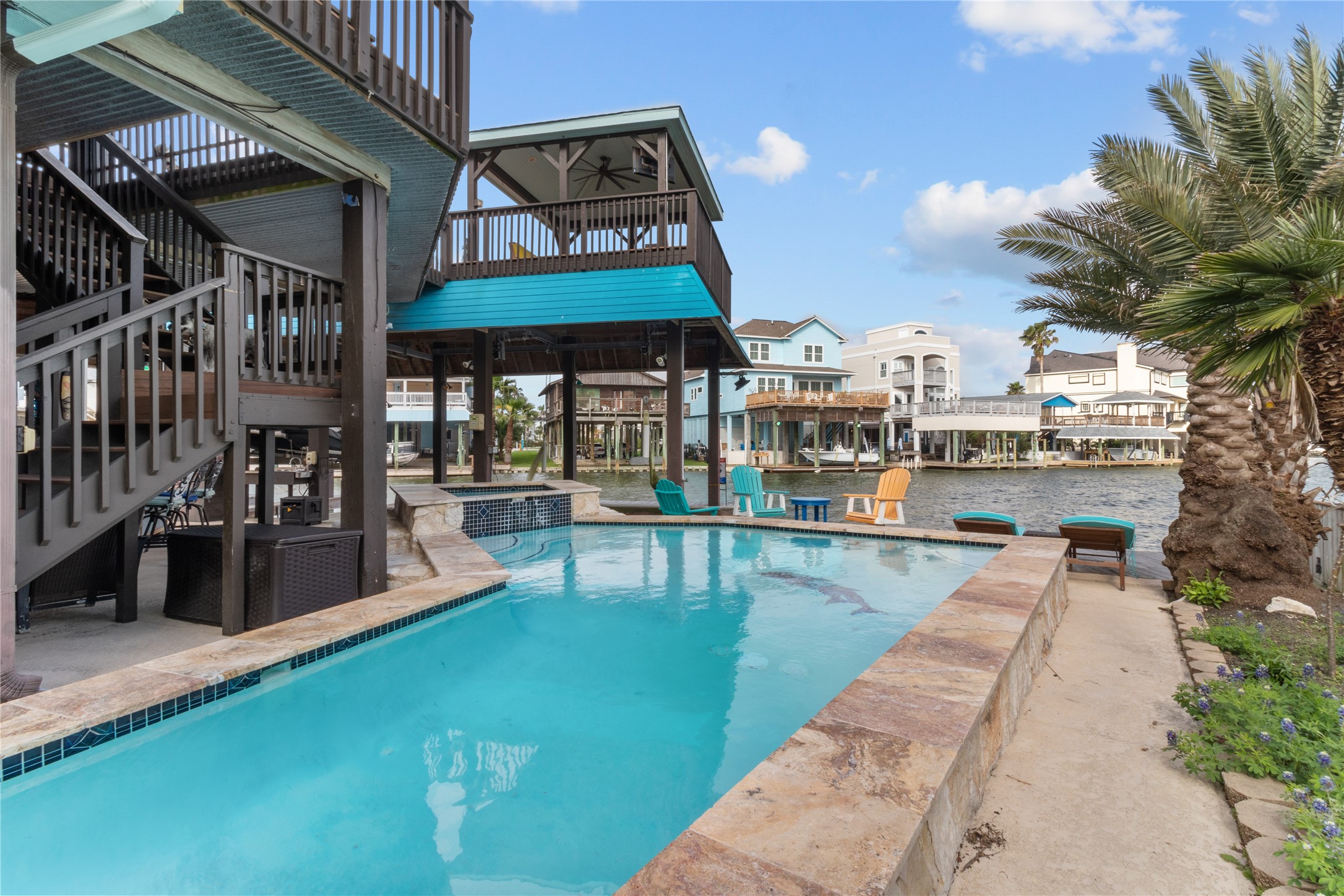 106 Isles End Road Tiki Island, TX 77554 - Photo 40 of 44 a view of a swimming pool with a patio