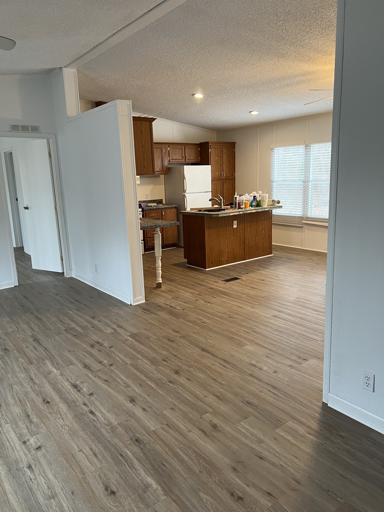 a large kitchen with cabinets and wooden floor