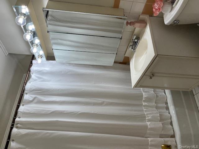 241-20 Northern Boulevard, Unit 3H Queens, NY 11362 - Photo 14 of 16 a bathroom with a sink and a mirror