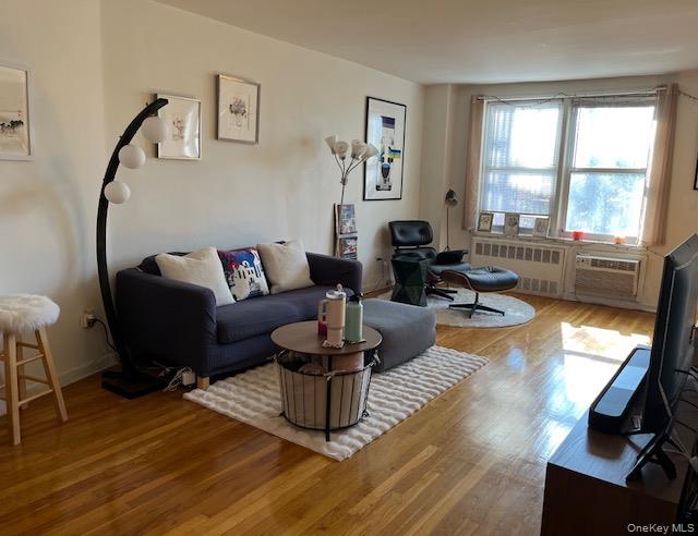 241-20 Northern Boulevard, Unit 3H Queens, NY 11362 - Photo 2 of 16 a living room with fireplace furniture and a large window