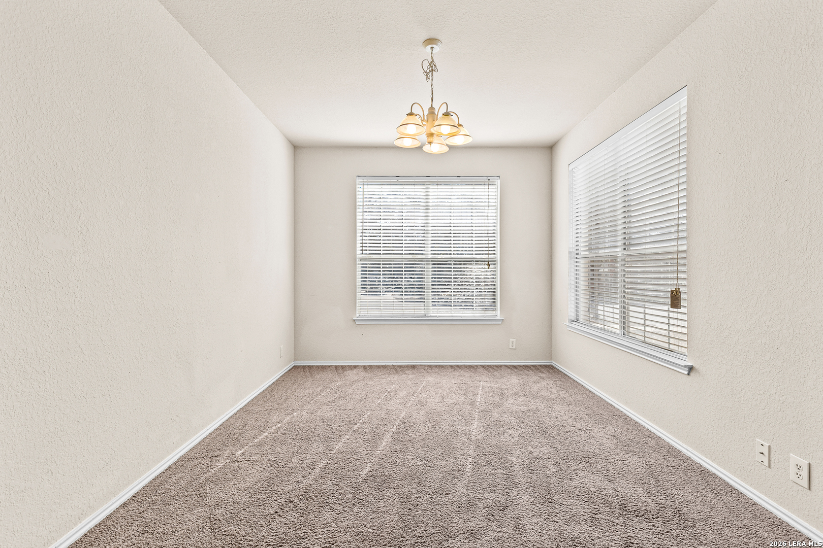 128 Pilot Cibolo, TX 78108 - Photo 13 of 49 an empty room with windows and chandelier