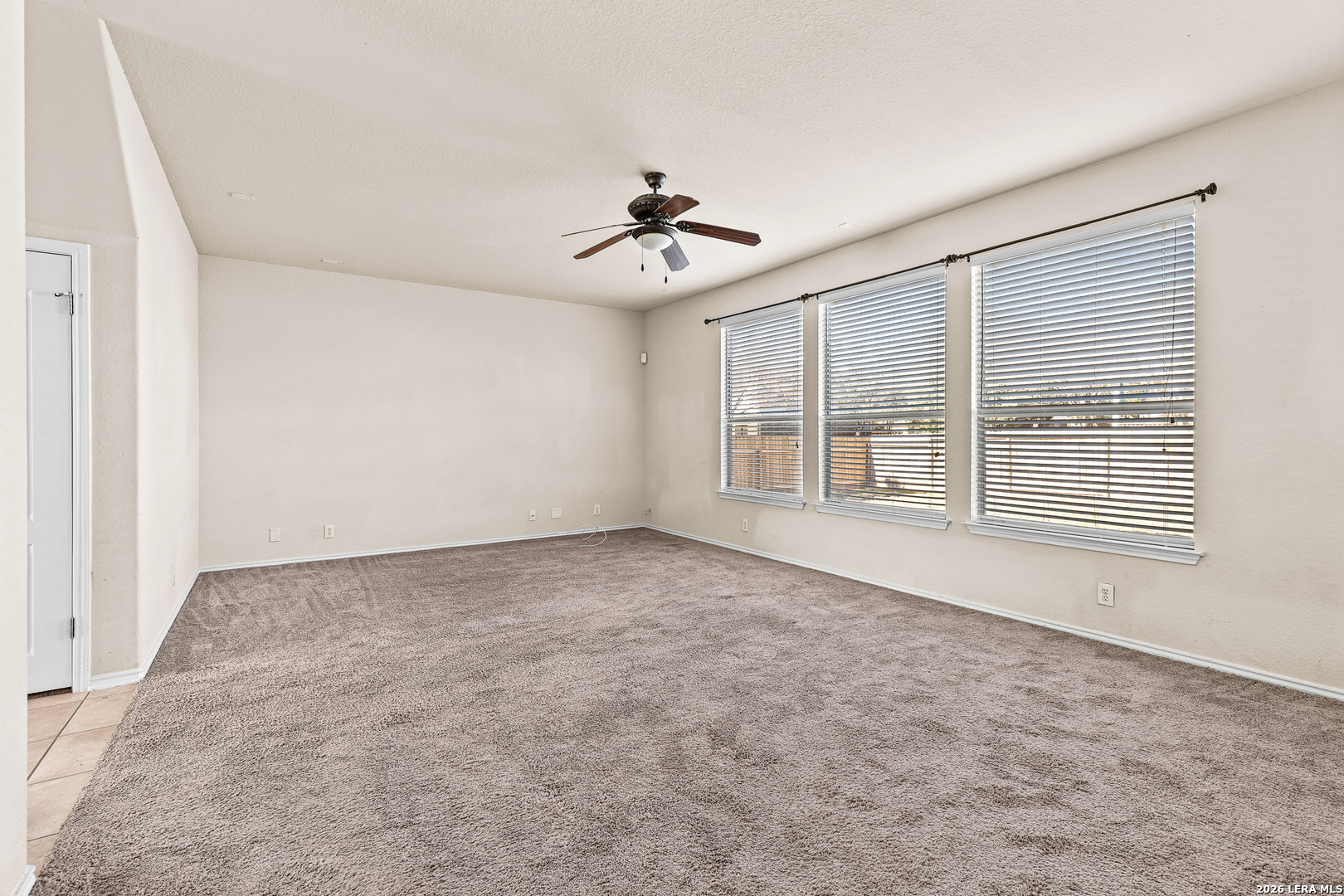 128 Pilot Cibolo, TX 78108 - Photo 21 of 49 an empty room with chandelier fan and windows