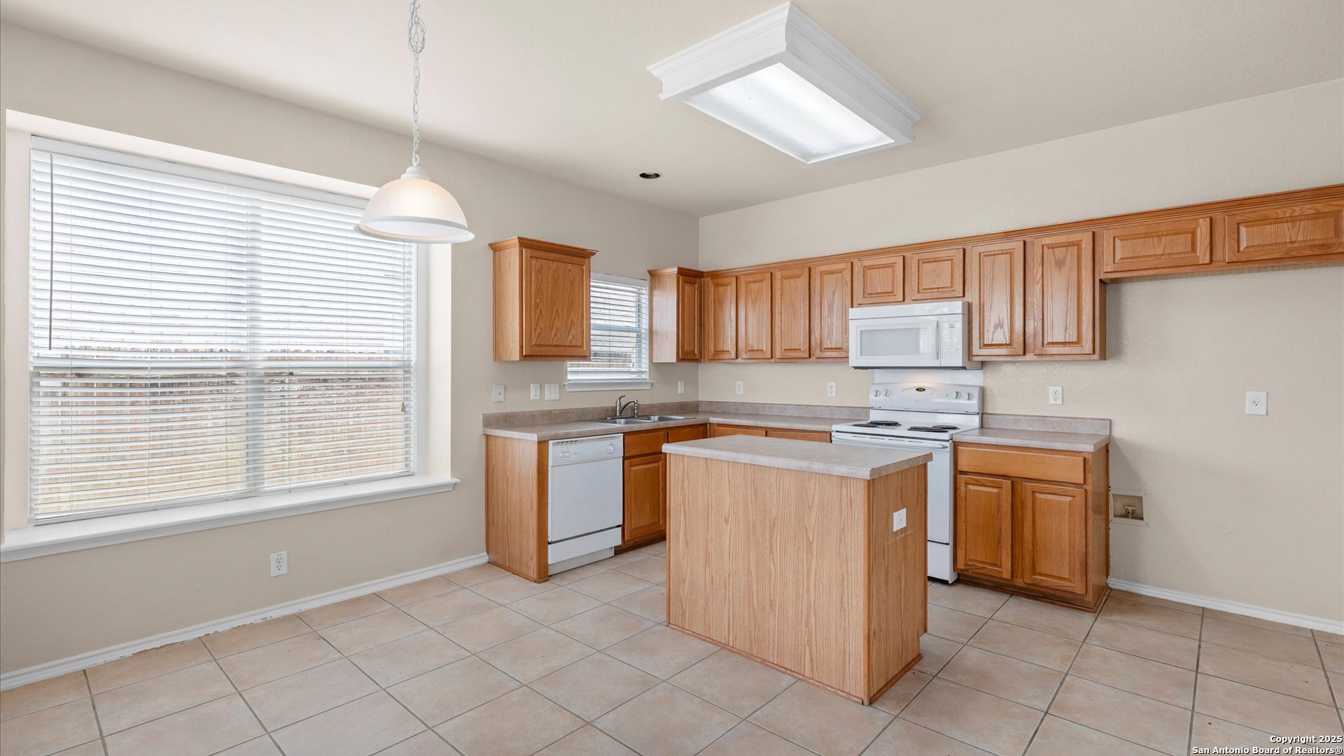 128 Pilot Cibolo, TX 78108 - Photo 4 of 22 a kitchen with stainless steel appliances granite countertop a stove a sink and a refrigerator