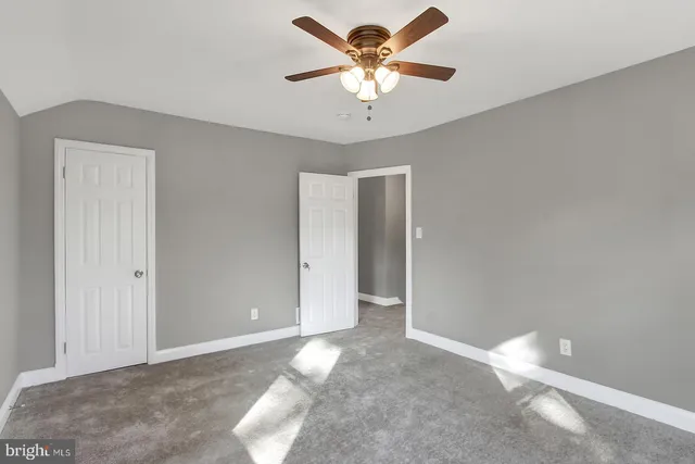 a view of a big room with chandelier fan
