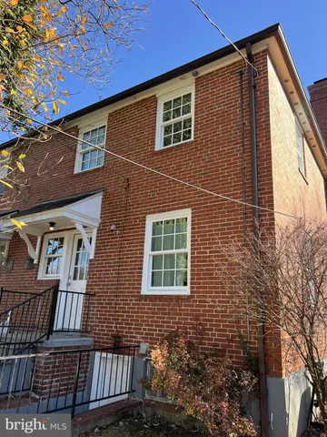 a view of a brick building next to a yard