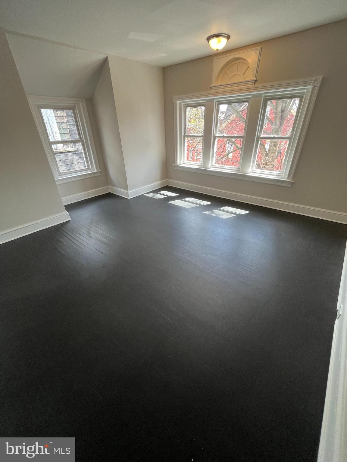 339 Chestnut Street, Unit 2 Pottstown, PA 19464 - Photo 17 of 19 an empty room with wooden floor and windows