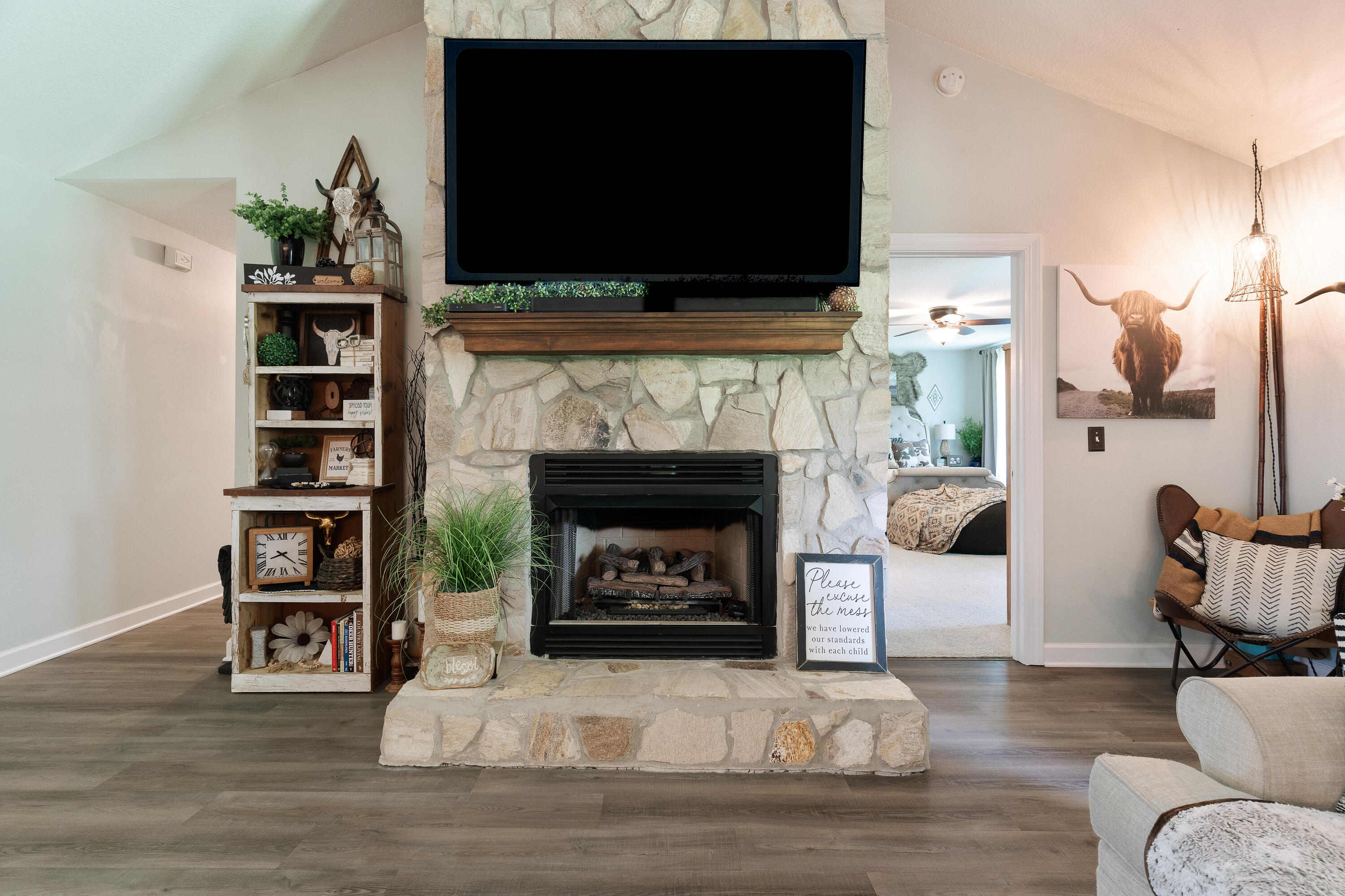 6263 Old River Road Baker, FL 32531 - Photo 29 of 69 a living room with furniture a flat screen tv and a fireplace