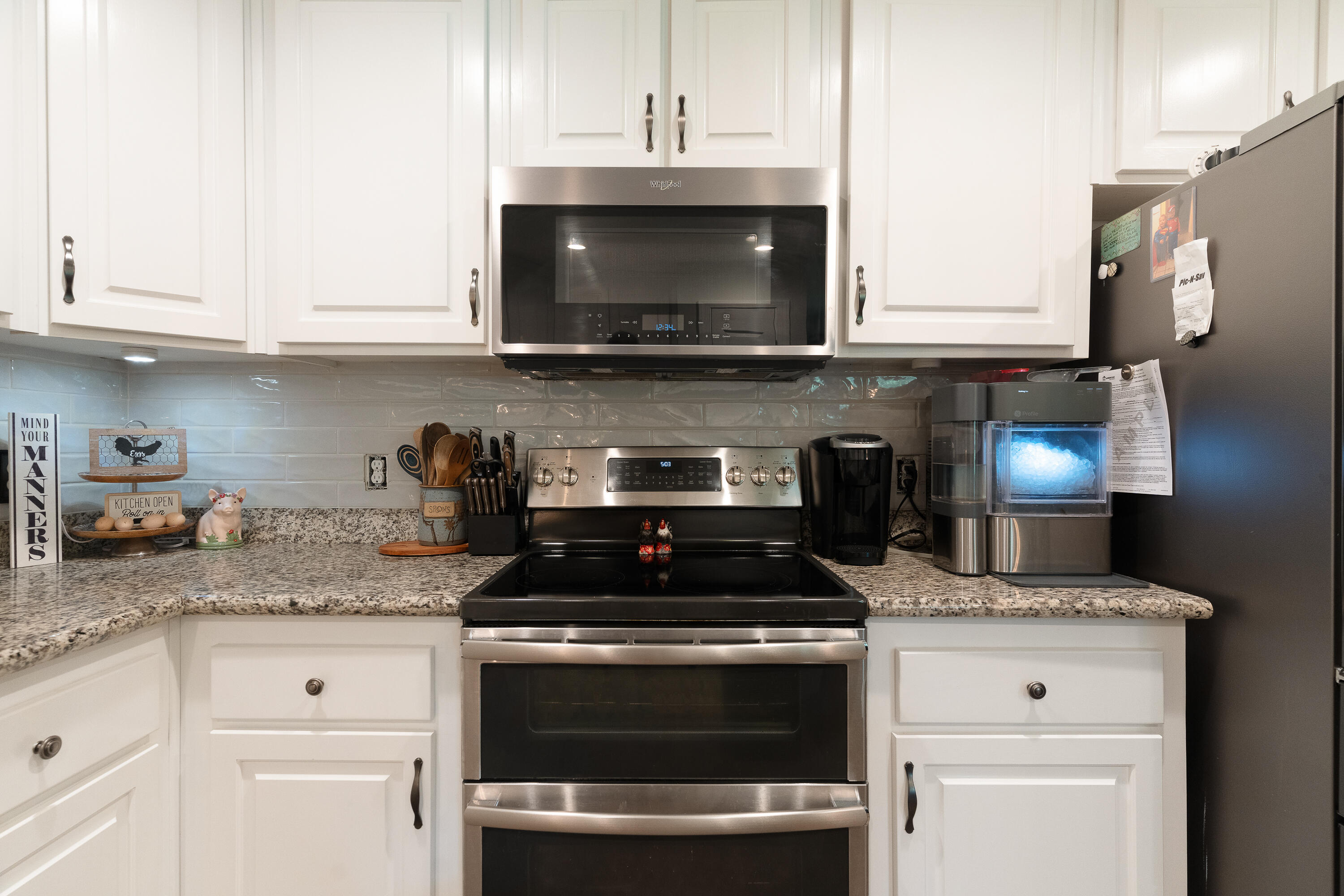 6263 Old River Road Baker, FL 32531 - Photo 36 of 69 a kitchen with granite countertop stainless steel appliances a stove a microwave a sink and cabinets