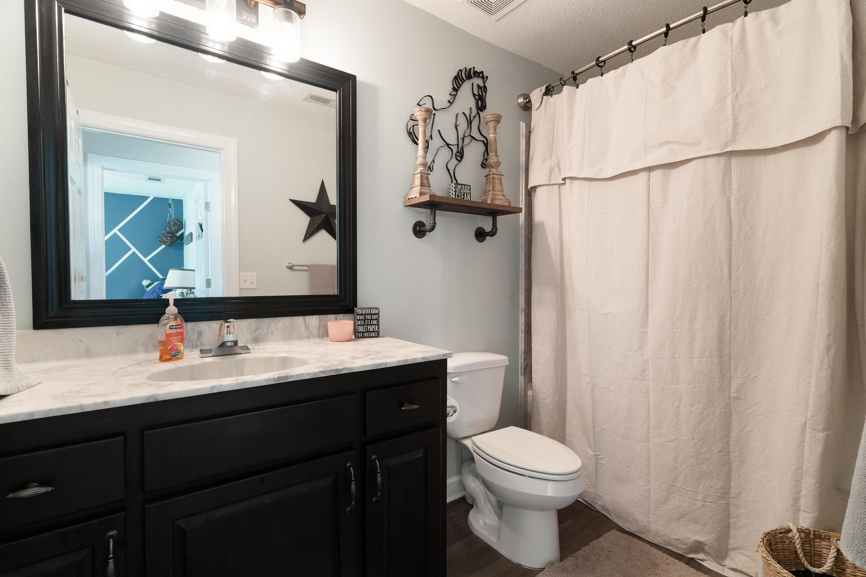 6263 Old River Road Baker, FL 32531 - Photo 52 of 69 a bathroom with a toilet sink vanity and mirror