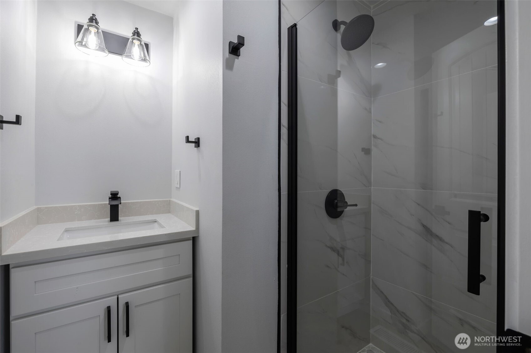 3611 Southwest 342nd Court Federal Way, WA 98023 - Photo 11 of 27 a bathroom with a sink vanity and shower