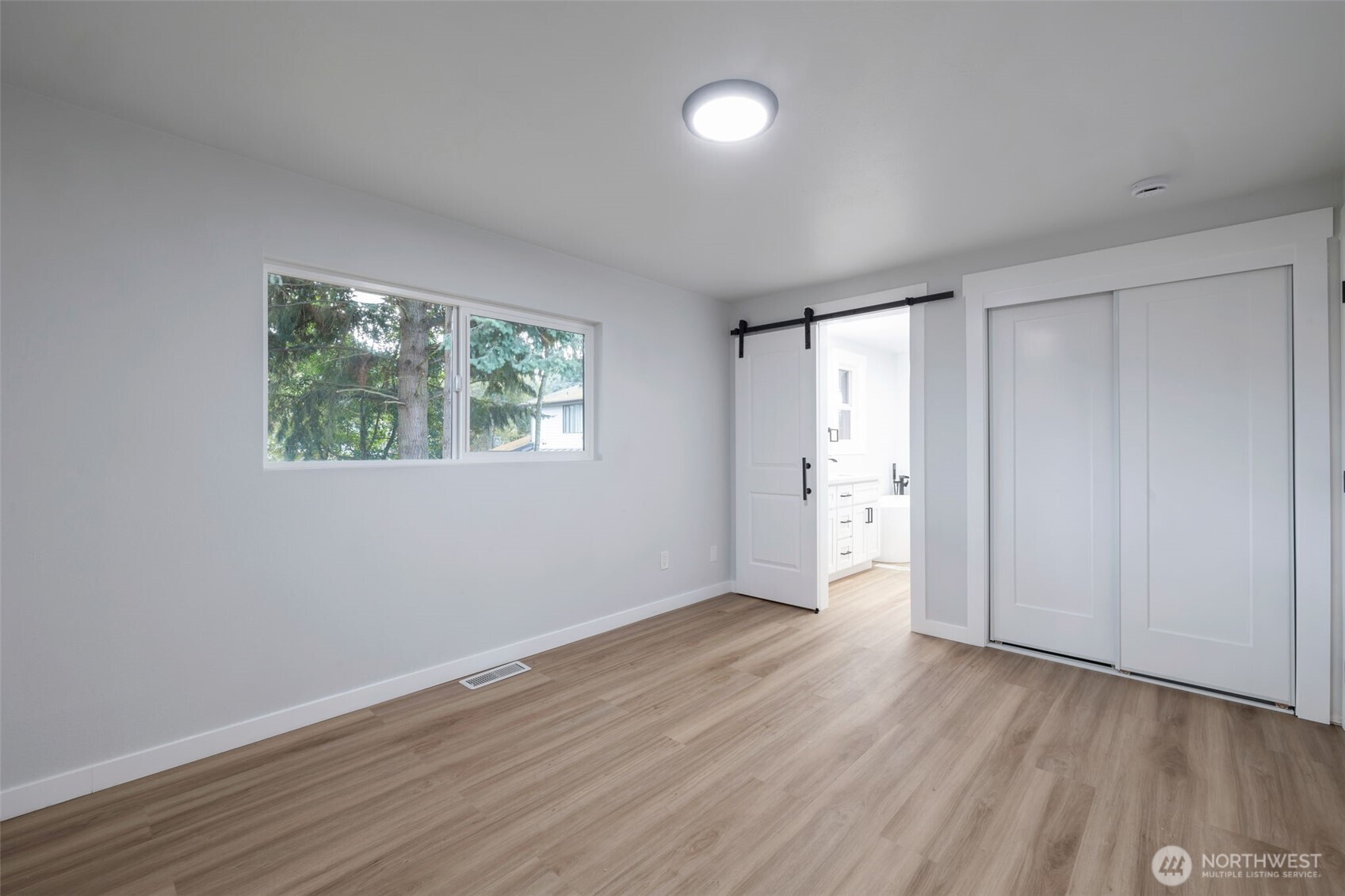 3611 Southwest 342nd Court Federal Way, WA 98023 - Photo 16 of 27 a view of an empty room with wooden floor and a window