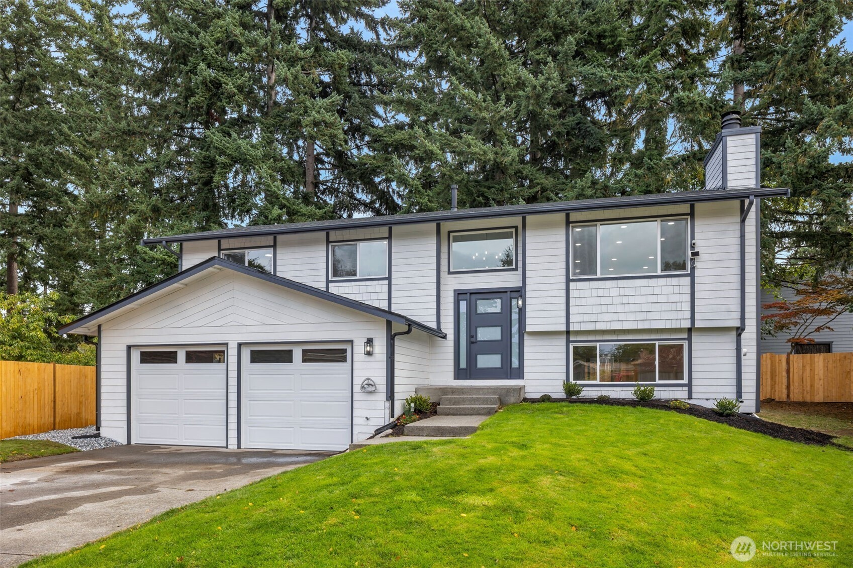 3611 Southwest 342nd Court Federal Way, WA 98023 - Photo 2 of 27 a front view of a house with a garden and yard