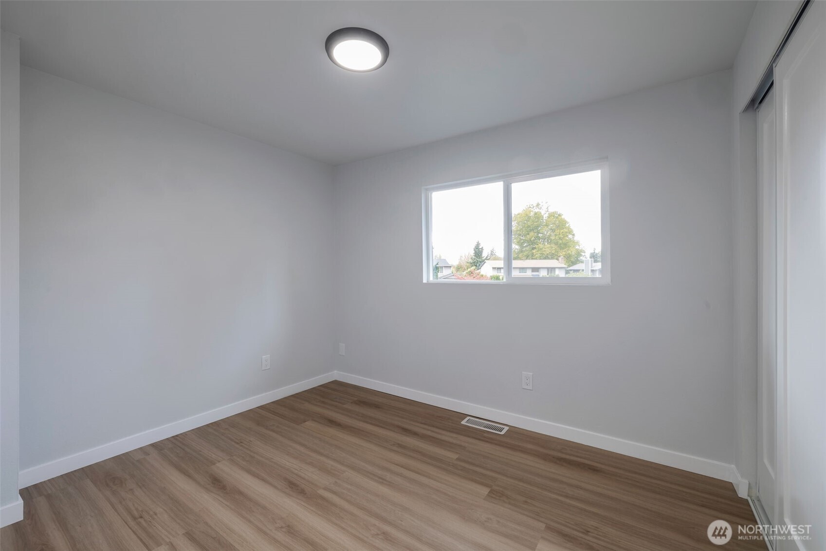 3611 Southwest 342nd Court Federal Way, WA 98023 - Photo 22 of 27 an empty room with wooden floor and windows