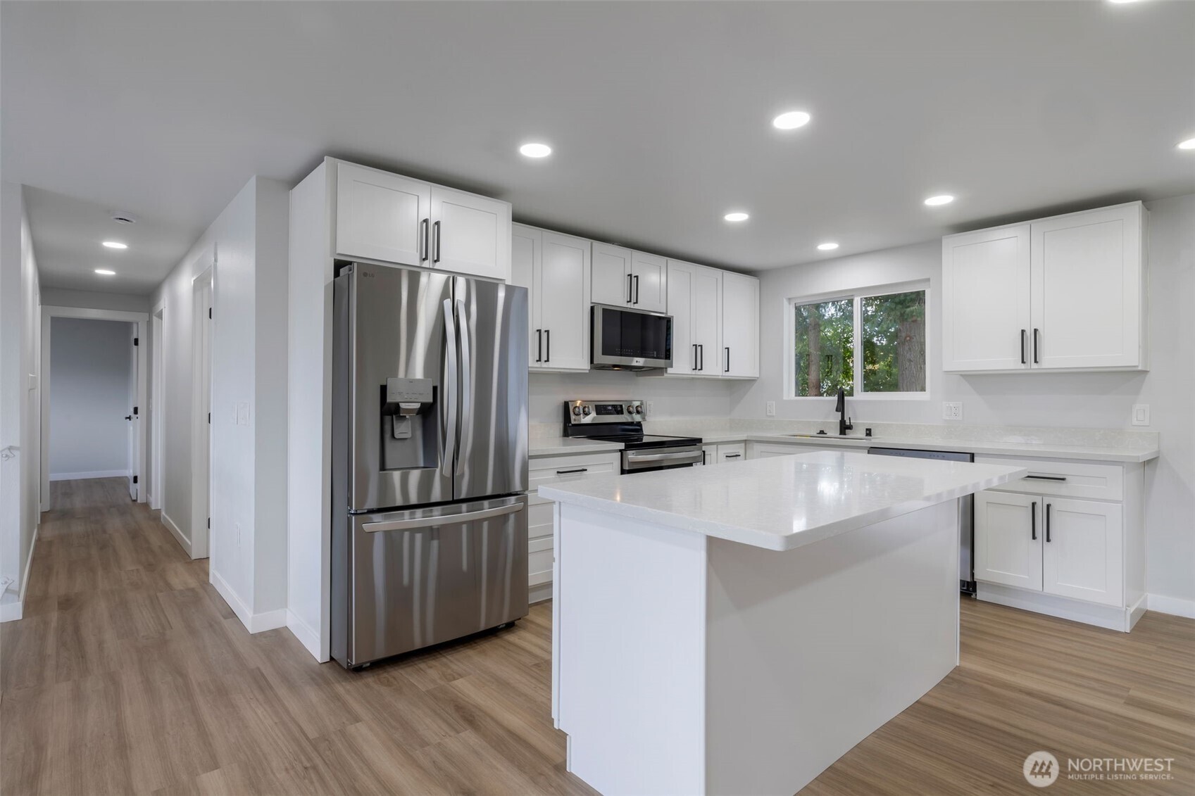 3611 Southwest 342nd Court Federal Way, WA 98023 - Photo 4 of 27 a kitchen with kitchen island granite countertop stainless steel appliances cabinets a sink and a counter top space
