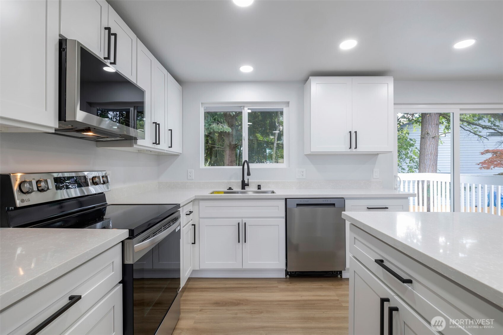 3611 Southwest 342nd Court Federal Way, WA 98023 - Photo 5 of 27 a kitchen with a sink stove top oven and cabinets