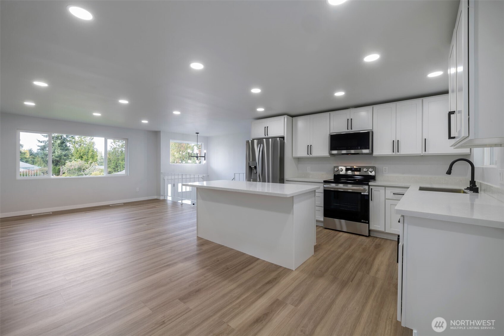 3611 Southwest 342nd Court Federal Way, WA 98023 - Photo 6 of 27 a kitchen with granite countertop a stove top oven a sink a counter space and cabinets