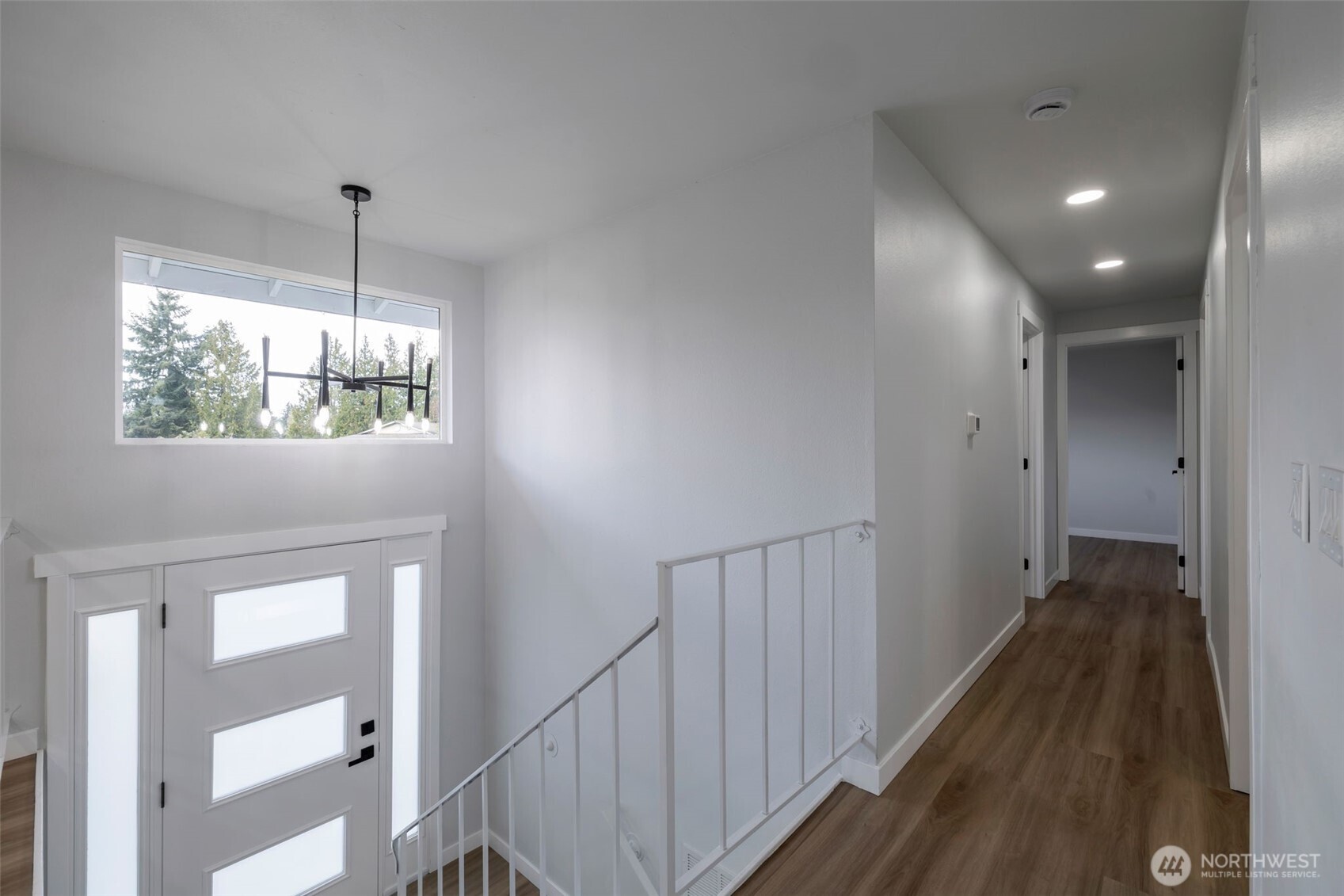 3611 Southwest 342nd Court Federal Way, WA 98023 - Photo 7 of 27 a hallway with wooden floor chandelier and entryway