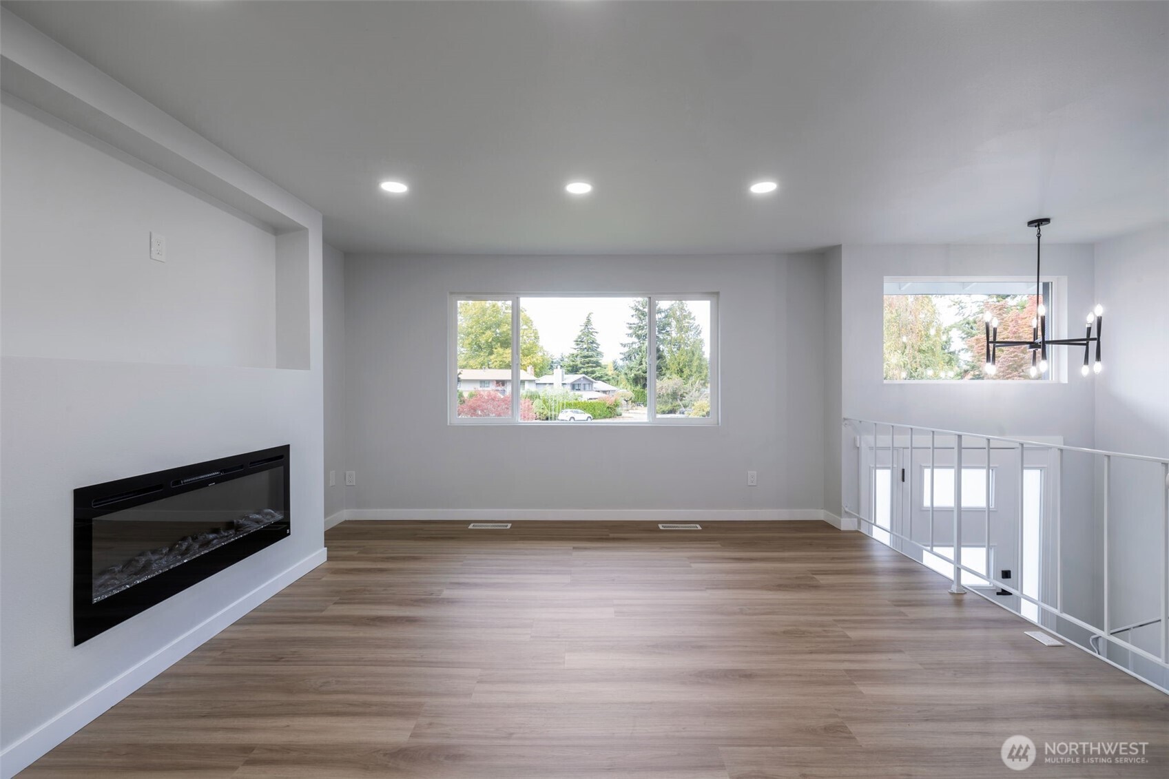 3611 Southwest 342nd Court Federal Way, WA 98023 - Photo 9 of 27 an empty room with wooden floor fireplace and windows