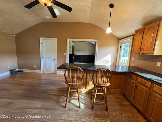 a view of a livingroom with furniture wooden floor and windows