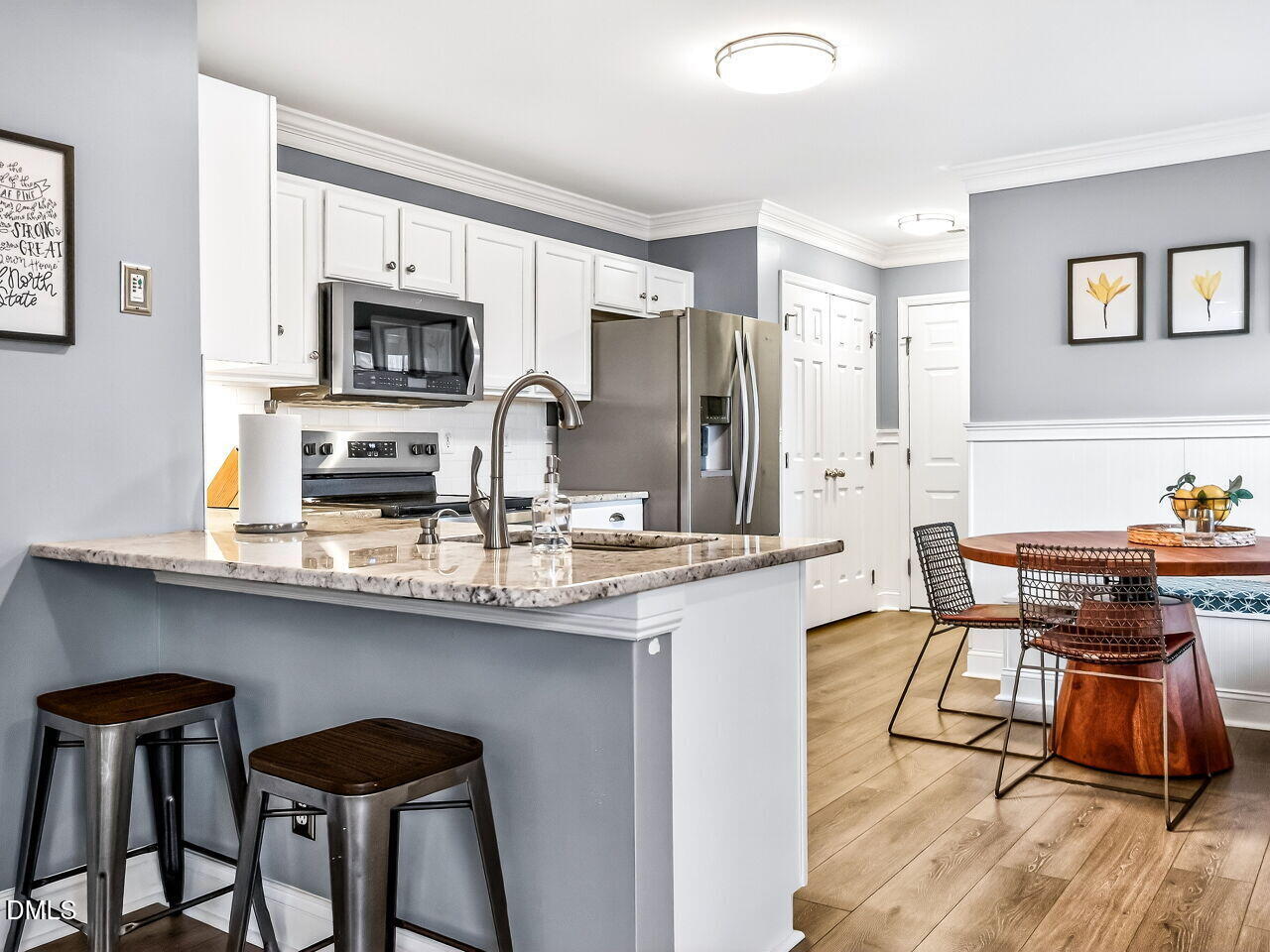 422 Intern Way Durham, NC 27713 - Photo 10 of 33 a kitchen with stainless steel appliances granite countertop a sink a stove a refrigerator cabinets and chairs