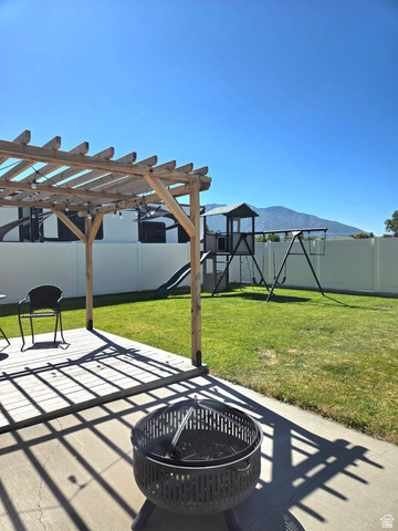 601 West 150 North, Unit 25 Springville, UT 84663 - Photo 28 of 29 Spacious backyard featuring a wooden pergola over a concrete patio and a manicured lawn