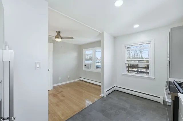 an empty room with windows and closet