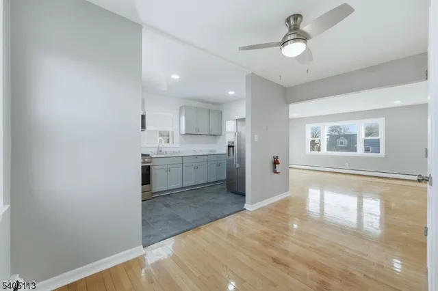 a view of a kitchen with wooden floor and a sink