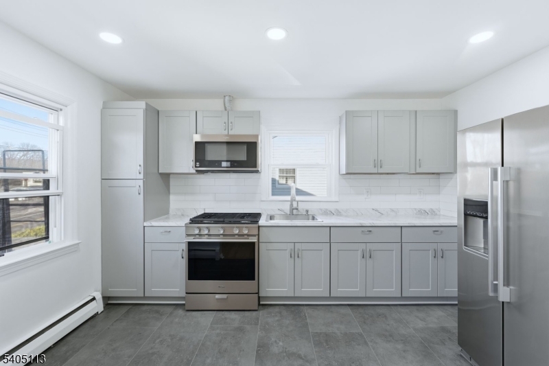 5 Josh Court Clifton, NJ 07011 - Photo 9 of 20 a kitchen with cabinets appliances and a window