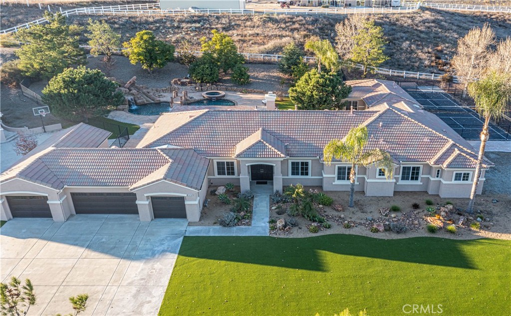 a aerial view of a house next to a yard