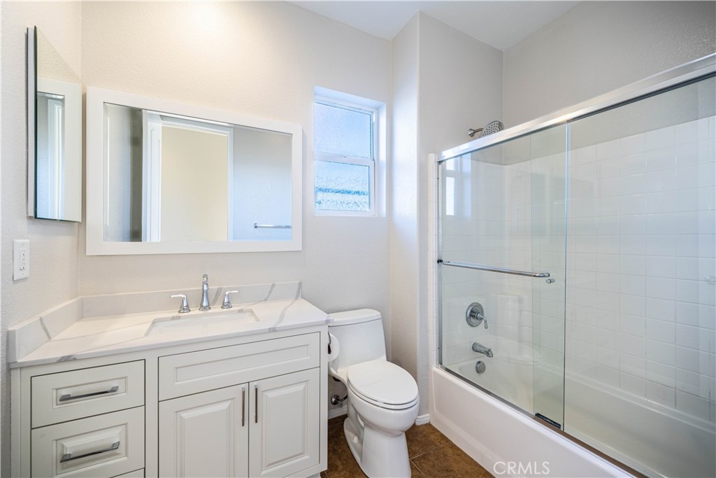 24195 Spencer Butte Drive Perris, CA 92570 - Photo 19 of 60 a bathroom with a sink a toilet and shower