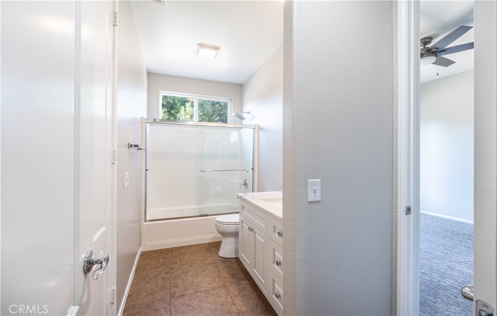24195 Spencer Butte Drive Perris, CA 92570 - Photo 20 of 60 a bathroom with a granite countertop sink mirror vanity and toilet