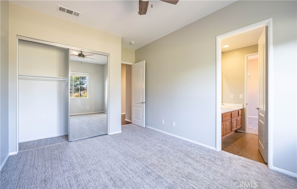 24195 Spencer Butte Drive Perris, CA 92570 - Photo 23 of 60 a view of a hallway with wooden shelves