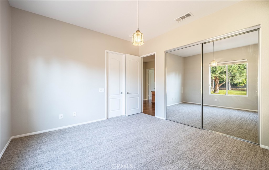 24195 Spencer Butte Drive Perris, CA 92570 - Photo 25 of 60 a view of a room with a ceiling fan and window