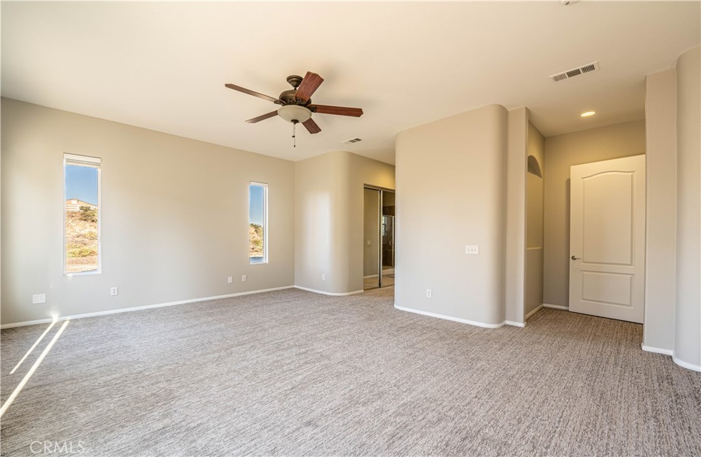 24195 Spencer Butte Drive Perris, CA 92570 - Photo 26 of 60 a view of empty room with wooden floor and ceiling fan