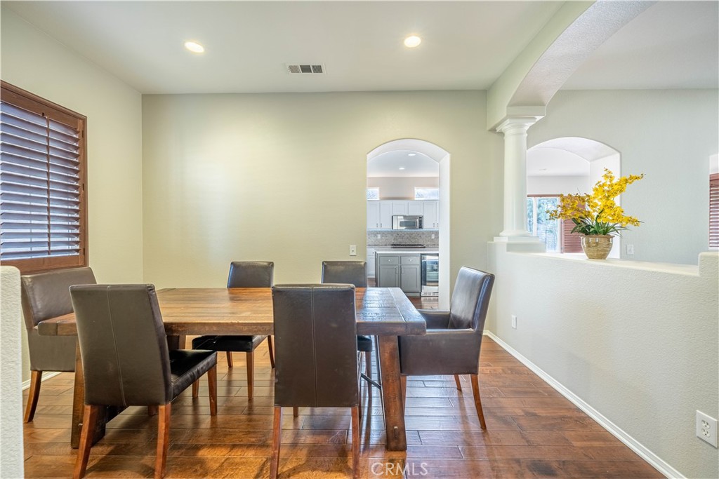 24195 Spencer Butte Drive Perris, CA 92570 - Photo 28 of 60 a view of a dining room with furniture a rug and wooden floor
