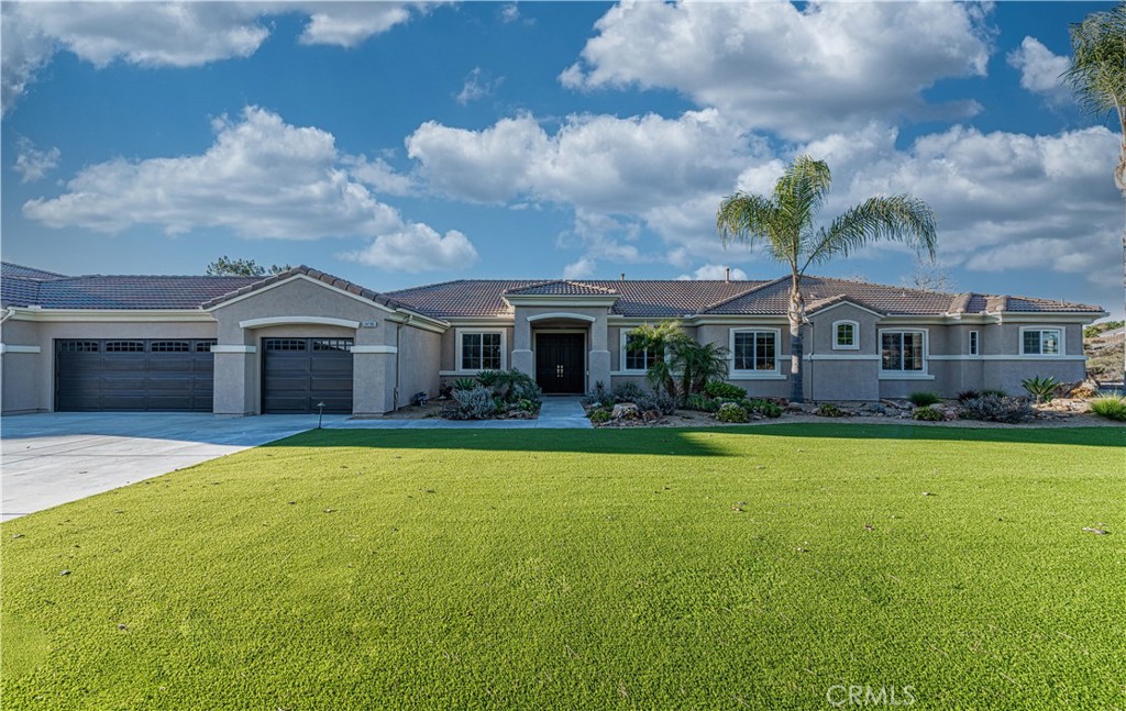 24195 Spencer Butte Drive Perris, CA 92570 - Photo 35 of 60 a front view of house with yard and green space