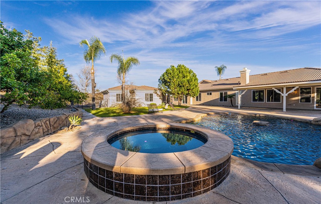 24195 Spencer Butte Drive Perris, CA 92570 - Photo 36 of 60 a view of a swimming pool with a patio