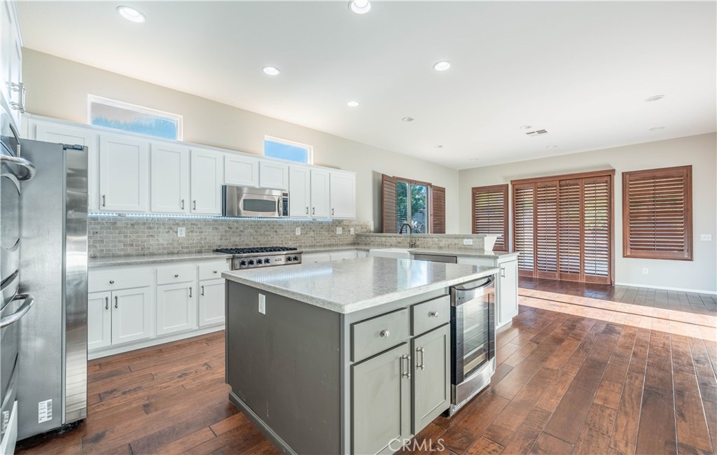 24195 Spencer Butte Drive Perris, CA 92570 - Photo 37 of 60 a kitchen with a sink stove and cabinets