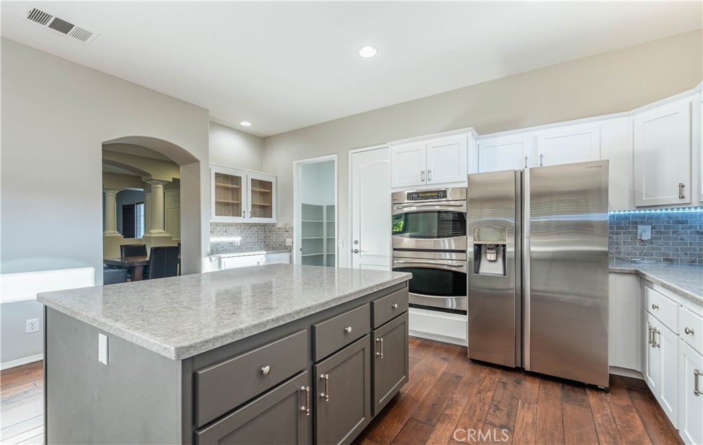 24195 Spencer Butte Drive Perris, CA 92570 - Photo 40 of 60 a kitchen with a refrigerator and a sink