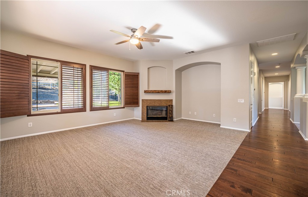 24195 Spencer Butte Drive Perris, CA 92570 - Photo 42 of 60 a view of a livingroom with a fireplace and windows