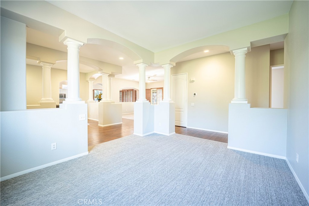 24195 Spencer Butte Drive Perris, CA 92570 - Photo 43 of 60 a view of a big room with wooden floor and a kitchen