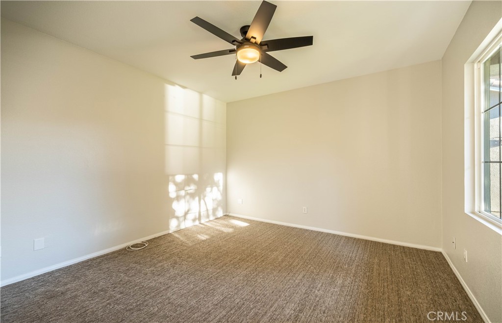 24195 Spencer Butte Drive Perris, CA 92570 - Photo 49 of 60 an empty room with windows and fan