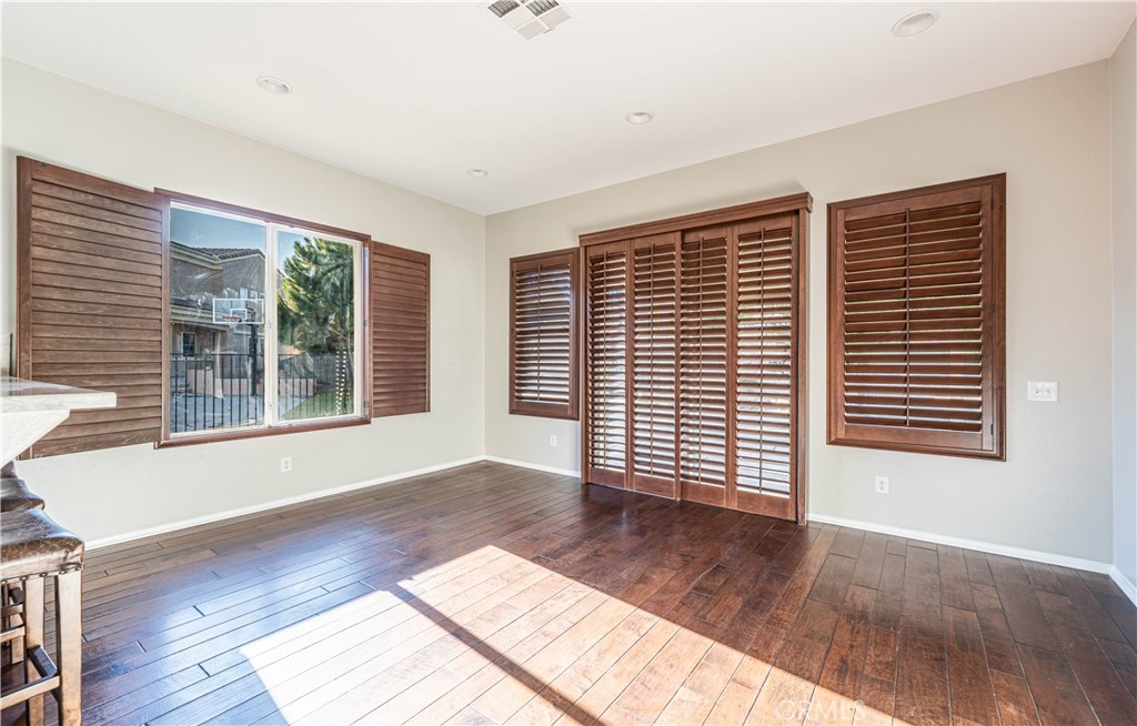 24195 Spencer Butte Drive Perris, CA 92570 - Photo 50 of 60 a view of an empty room with wooden floor and a window
