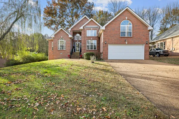 a front view of a house with a yard and garage