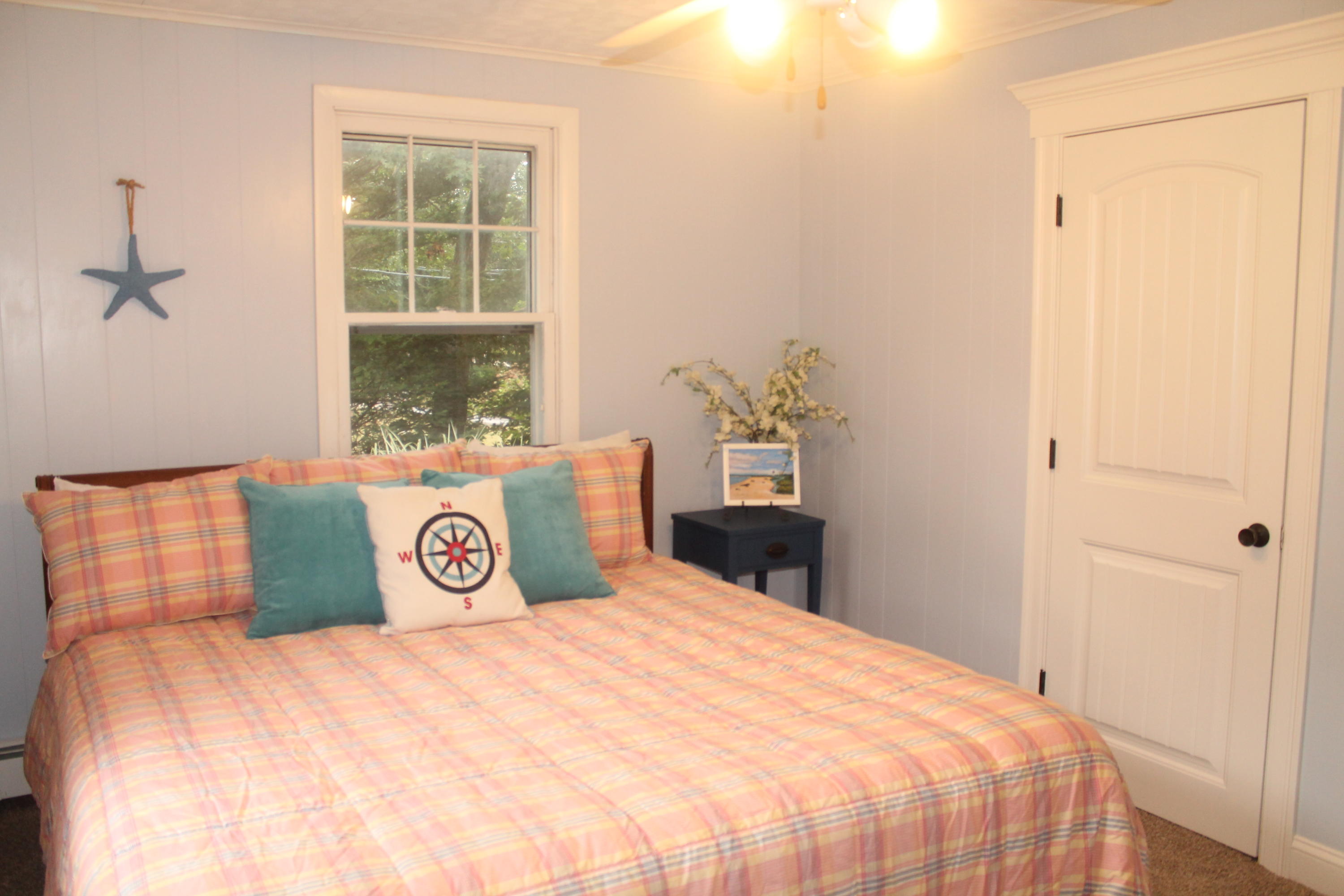 4 Frederick Road Falmouth, MA 02540 - Photo 11 of 27 a bedroom with a bed and wooden floor