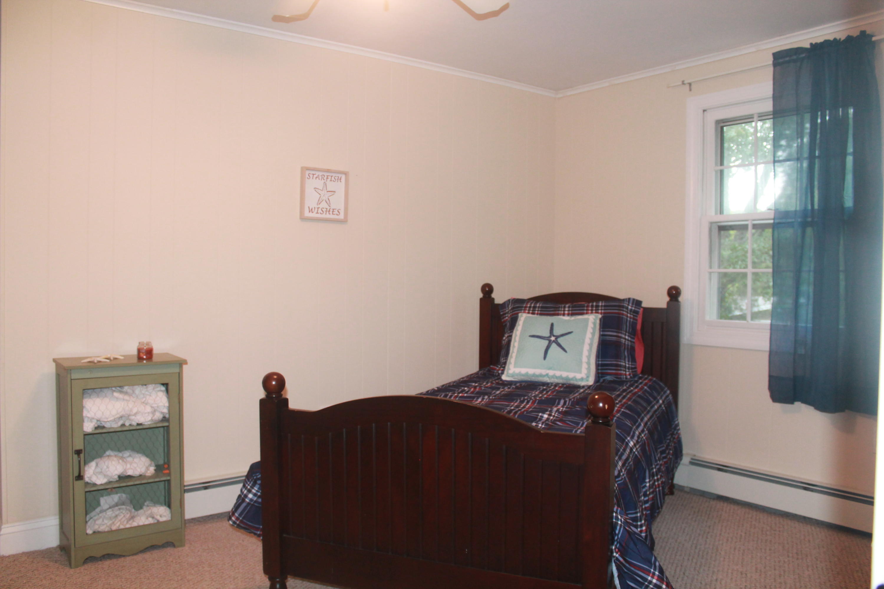 4 Frederick Road Falmouth, MA 02540 - Photo 13 of 27 a bed sitting in a bedroom next to a window