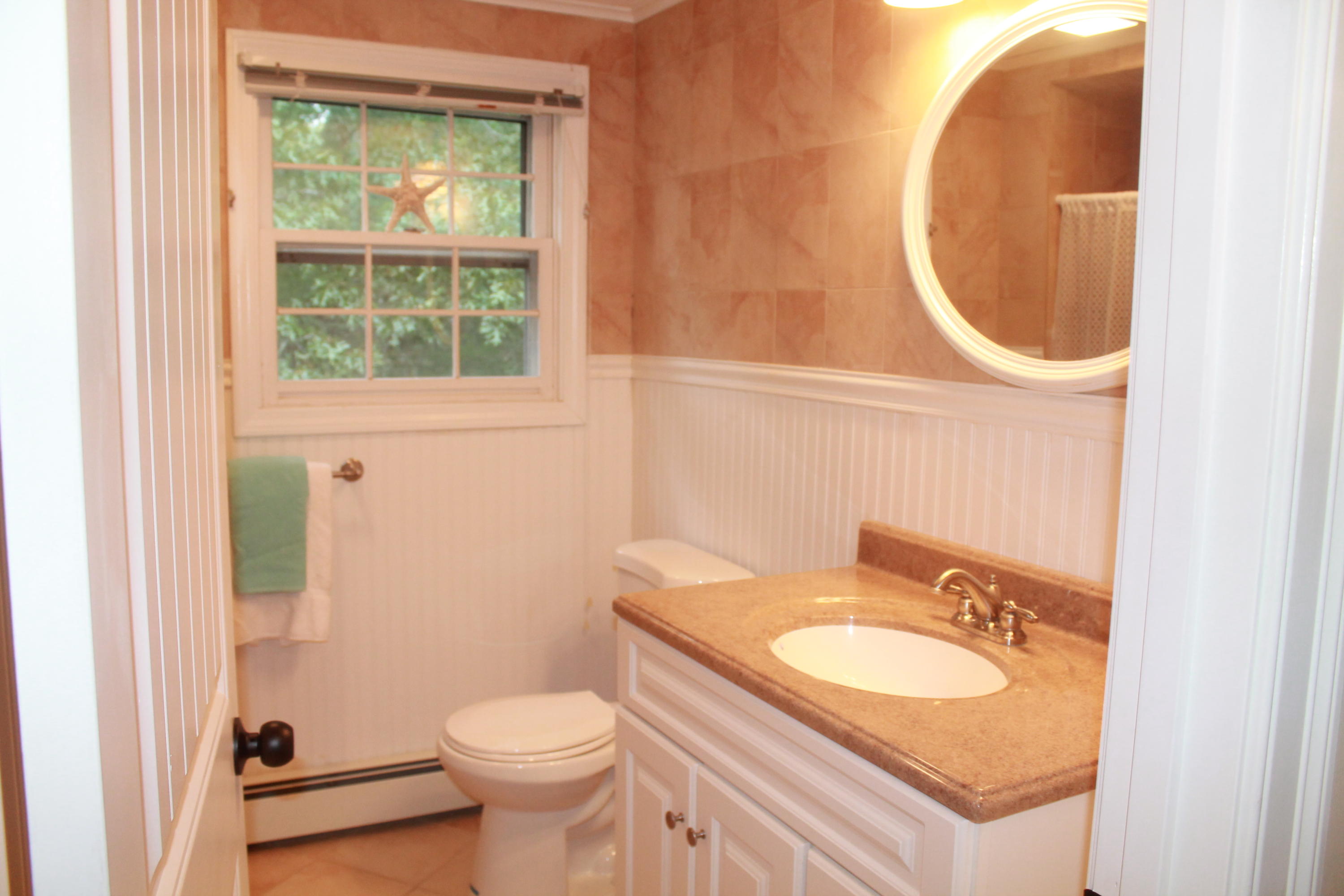 4 Frederick Road Falmouth, MA 02540 - Photo 19 of 27 a bathroom with a granite countertop toilet and a sink