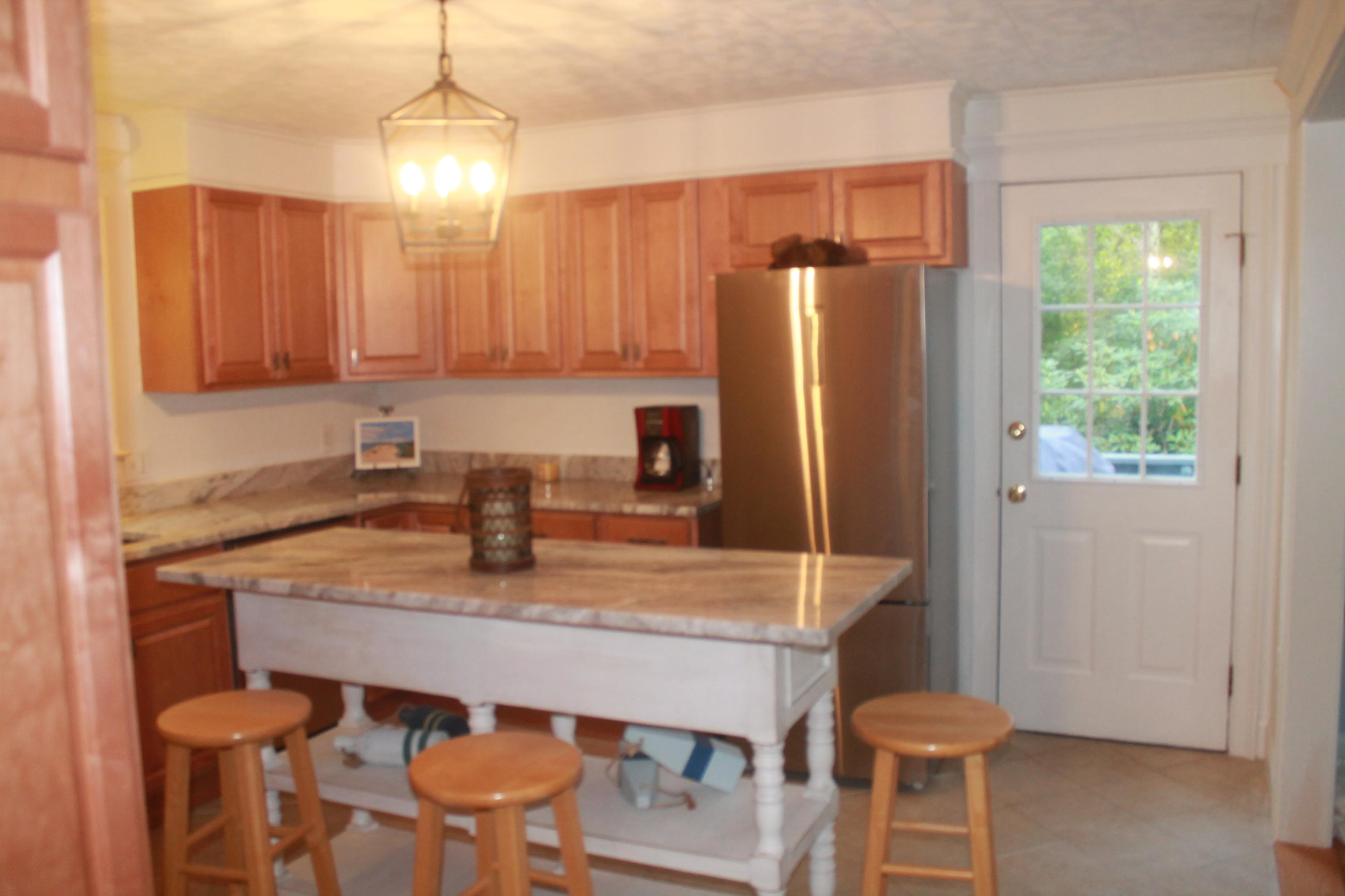4 Frederick Road Falmouth, MA 02540 - Photo 7 of 27 a kitchen with a table chairs refrigerator and microwave