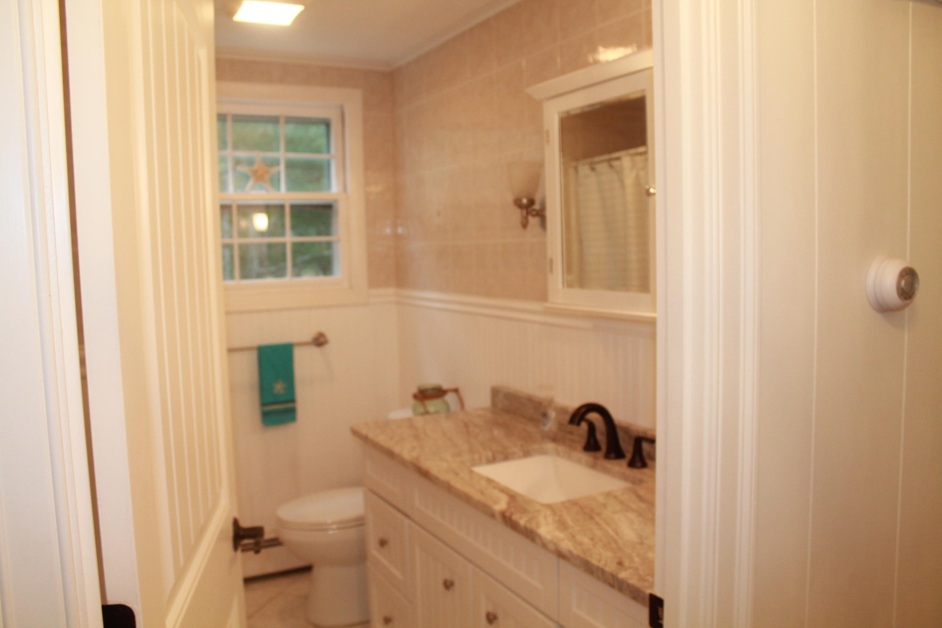 4 Frederick Road Falmouth, MA 02540 - Photo 9 of 27 a bathroom with a granite countertop sink and a toilet